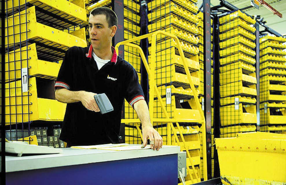 Metals_Mnuafacturer_Case_Study Man Scans Barcode to Register an Item on Horizontal Carousel